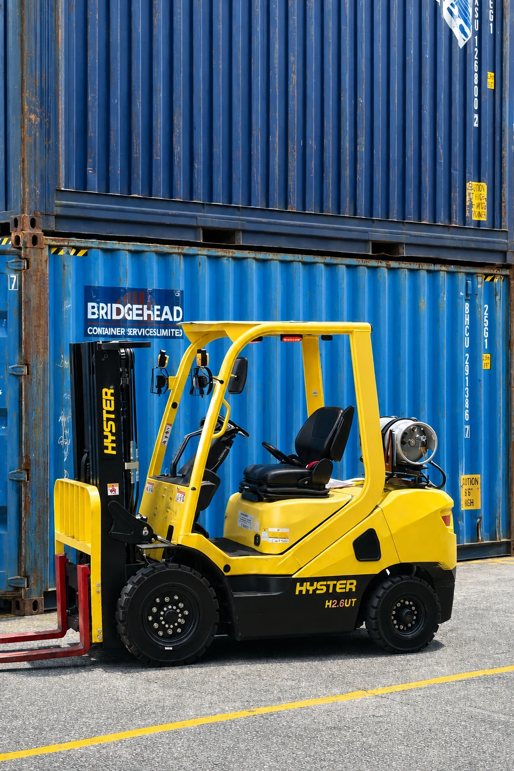 Forklift operating beside shipping containers